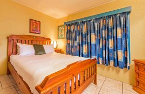 a bedroom with a bed and a large window at Clifton Beach House in Clifton Beach