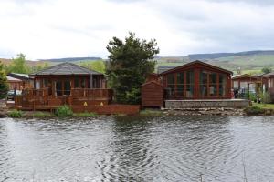 a house on the side of a body of water at Sunnyside Lodge in Dunning Station