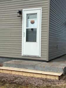 a white door on the side of a house at The Gateway Suite in Fortune