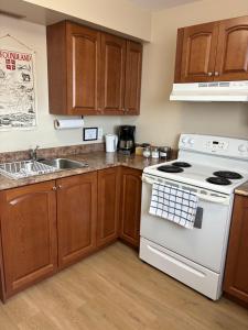 a kitchen with a white stove and a sink at The Gateway Suite in Fortune