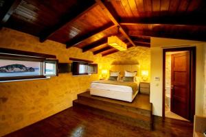 A bed or beds in a room at Exensian Villas & Suites