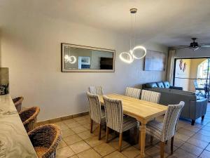 a dining room and living room with a table and chairs at Princesa C206 -Arcade Game-Experience Rocky Point- in Puerto Peñasco