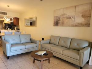 a living room with two couches and a coffee table at Princesa C206 -Arcade Game-Experience Rocky Point- in Puerto Peñasco
