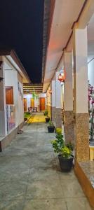 an empty hallway of a building with potted plants at Hotel Shandira in Taliwang