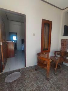 a room with a wooden table and a mirror at Hotel Shandira in Taliwang