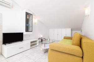 a living room with a couch and a television at Apartments with parking space Rabac, Labin - 6464 in Rabac