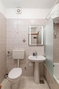 a bathroom with a white toilet and a sink at Apartments with parking space Rabac, Labin - 6464 in Rabac +39 photos