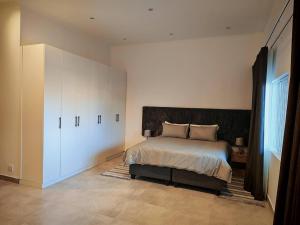 a bedroom with a bed and a large closet at King Superior Studio Room with En-Suit in Cape Town +19 photos