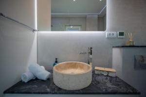 a bathroom with a large bowl sink on a counter at Caelum Et Mare in Donja Lastva +27 photos