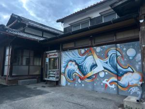 a building with a mural on the side of it at Seven base Yoshiumi in Imabari