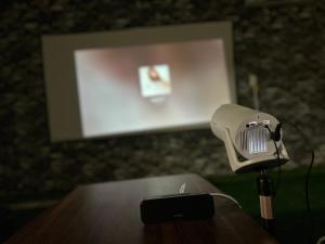a microphone on a table in front of a screen at Seven base Yoshiumi in Imabari