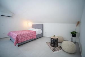 a bedroom with a bed and a table and chairs at Caelum Et Mare in Donja Lastva