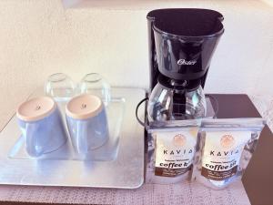 a blender and two cups on a tray at Condohotel Luciana Deluxe Queen Oceanview Suite with Sofabed in Playa del Carmen