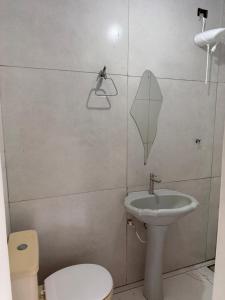 a bathroom with a sink and a toilet at Pousada brandt Ap 3 in Campo Grande +2 photos