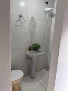 a bathroom with a sink and a toilet at Pousada brandt Ap 3 in Campo Grande
