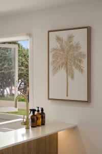 a picture of a palm tree on a wall above a kitchen counter at Little Waves Tugun in Gold Coast