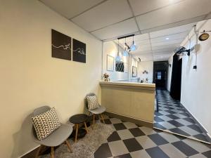a waiting room with two chairs and a counter at Ellhavfiz Homestay in Tapah