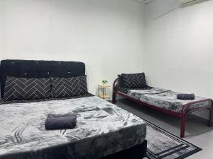 a bedroom with a bed and a couch in it at Ellhavfiz Homestay in Tapah
