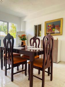 a dining room with a wooden table and chairs at Estancia Dulce Hogar, en pedernales in Pedernales