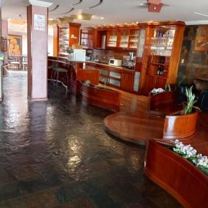 a lobby of a hotel with a flooded floor at Hotel Raices in Ambato