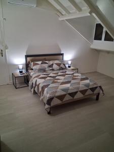 a bedroom with a bed and two night stands at La terrasse in Baie-Mahault