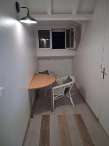 a small room with a table and a chair at La terrasse in Baie-Mahault