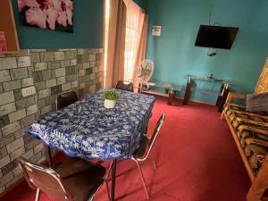 a dining room with a table with a plant on it at Hospedaje henua roa 2 in Hanga Roa