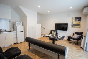 a living room with a table and a kitchen at Shiro in Hakodate