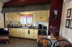 a kitchen with white cabinets and a table with a tableablish at The Lake House in Weed