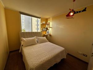 a small bedroom with a bed with a window at Laguna del Mar, C 208 in La Serena +18 photos