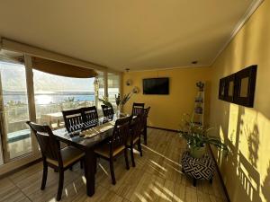 a dining room with a table and chairs and a window at Laguna del Mar, C 208 in La Serena