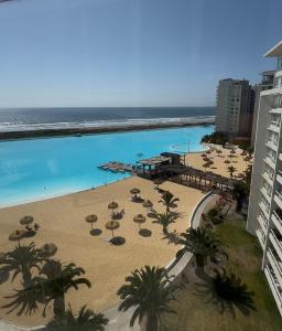 an aerial view of a beach with umbrellas and the ocean at Laguna del Mar, C 208 in La Serena