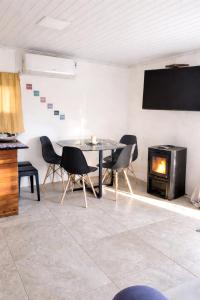 a dining room with a table and a fireplace at Renacer in Piriápolis