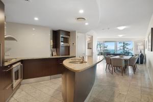 a kitchen and dining room with a dining table at Sirocco 507 by G1 Holidays in Mooloolaba