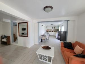 a living room with a couch and a table at A Serene Studio in Vieux Fort