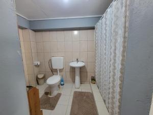 a small bathroom with a toilet and a sink at A Serene Studio in Vieux Fort