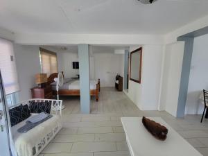 a living room with a bed and a couch at A Serene Studio in Vieux Fort