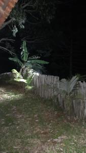 a wooden fence in a yard at night at Chalé aconchego sfx in São José dos Campos +7 photos