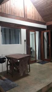 a wooden table in the middle of a room at Chalé aconchego sfx in São José dos Campos