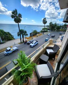 a balcony with a view of a street with cars at Hotel La Llave del Mar Zona Colonial in Santo Domingo +34 photos