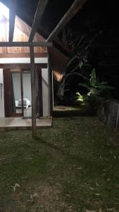 an open door of a house at night at Chalé aconchego sfx in São José dos Campos