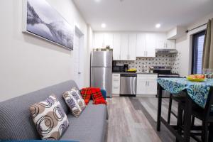 a kitchen with a couch and a table in a room at Cozy stays in Montreal +247 photos