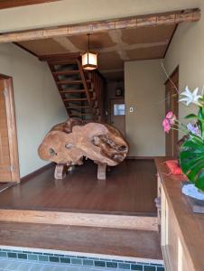 a large dinosaur head sitting on the floor of a room at Y House in Kurashiki