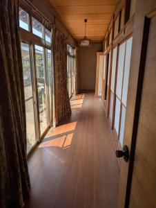 an empty hallway with large windows in a house at Y House in Kurashiki