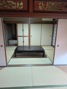 an empty room with a table in the middle at Y House in Kurashiki +7 photos
