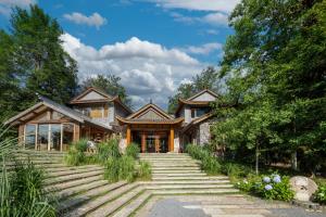 a house with stairs leading up to it at Evergreen Forest Retreat Zhangjiajie, Near National Forest Park Avator Park, Luxury Nature Escape, Free Airport&Train Shuttle Service & Travel itinerary, English Speaking Butler in Zhangjiajie