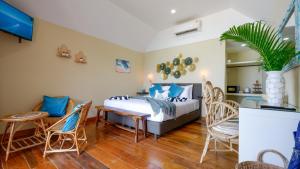 a bedroom with a bed and a table and chairs at Azul Beach Resort in Bophut