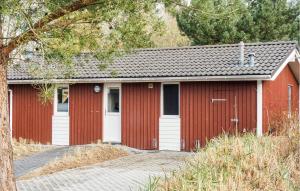 a red garage with a white door at Schatzkiste 3 - Dorf 4 in Travemünde