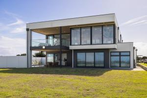 a large modern house with glass windows at Island View San Remo in San Remo