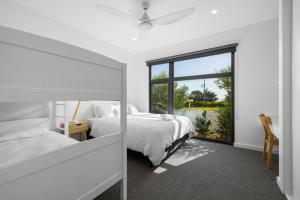 a bedroom with two beds and a window at Island View San Remo in San Remo +23 photos